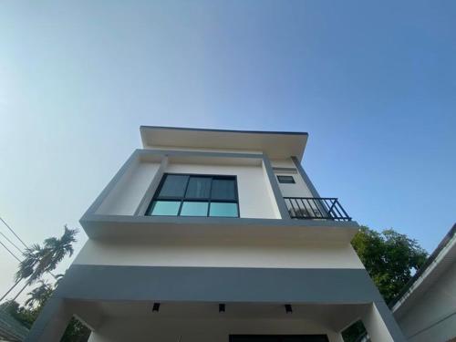 卡农Okat pool villa khanom的白色的房子,上面设有阳台