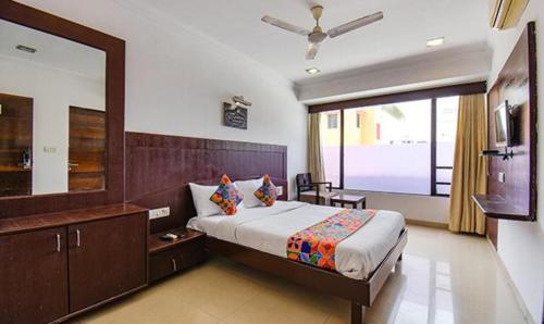 舍地Hotel Shree Sai Wada Shirdi的一间卧室设有一张大床和一个大镜子