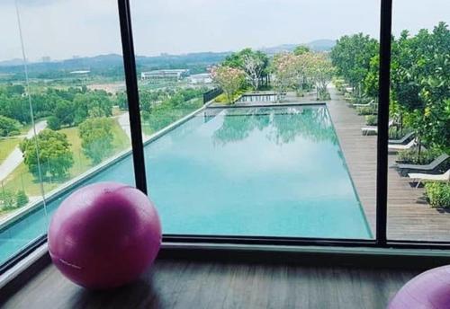 塞贝维Islamic Santai Santai Homestay - Centrus Soho Cyberjaya的窗户前的游泳池,有粉红色的球