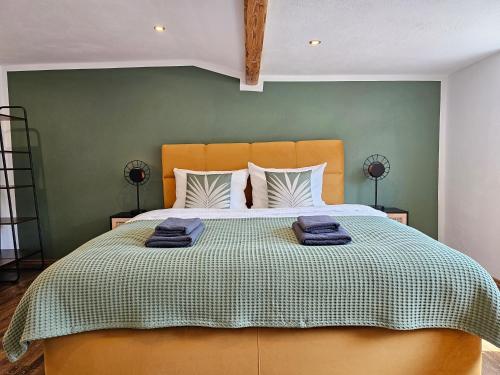 兰河畔马尔堡Tucan - Rooftop Terrace with View, BBQ, PS4+Stream的一间卧室设有一张大床和绿色的墙壁