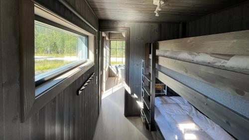 菲奈斯达伦Kåvanstugan Funäsdalen的小房间设有双层床和窗户