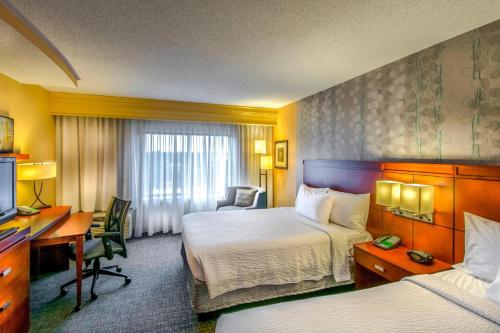 格林斯伯勒格林斯博罗机场万怡酒店的酒店客房配有两张床和一张书桌