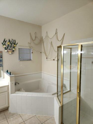 基西米Bahama Bay 116的带浴缸和玻璃淋浴间的浴室