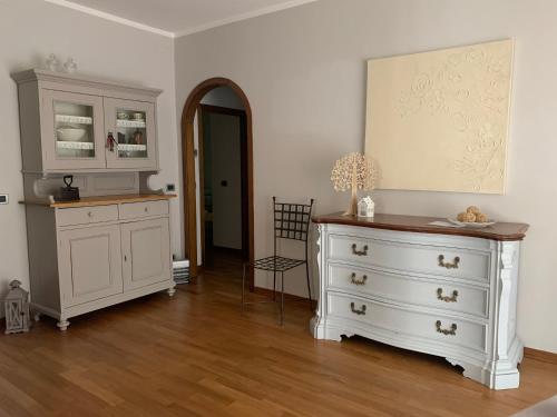 阿雷佐Home53的一间设有白色橱柜和梳妆台的房间