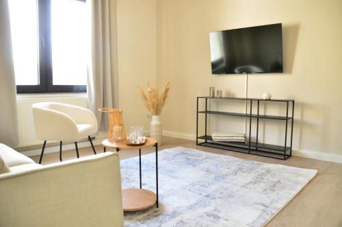 MILPAU Bottrop 2 - Modernes und zentrales Premium-Apartment für 4 Personen mit Queensize-Bett und Einzelbetten - Netflix, Nespresso und Smart-TV的电视和/或娱乐中心