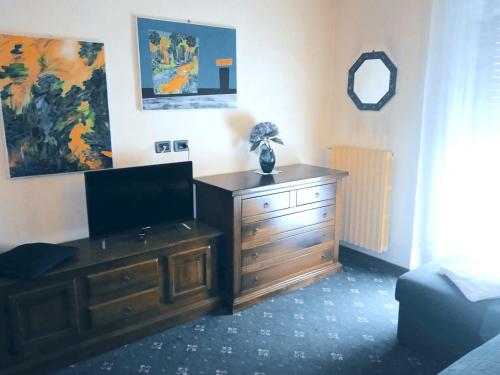 都灵帕科菲拉酒店的一间设有木制梳妆台的房间,里面配有电视
