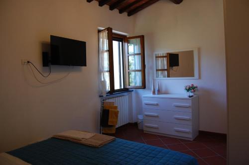 卡尔奇Casa VALGRAZIOSA的卧室配有一张床,墙上配有电视。