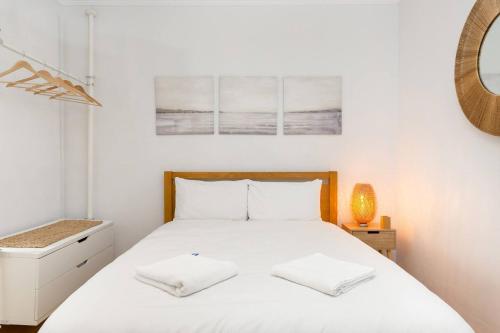 悉尼The Haven on Campbell - A Bondi Beachfront Address的卧室配有白色床和2个白色枕头