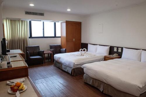 台中市友爱富豪国际大饭店  的酒店客房配有两张床和一张书桌