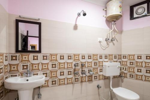 达兰萨拉Vella Marina Group of hotels Mcleodgunj的一间带水槽、卫生间和镜子的浴室