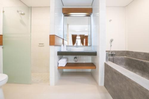 塞米亚克Villa Bunga Hotel的一间带水槽、卫生间和镜子的浴室
