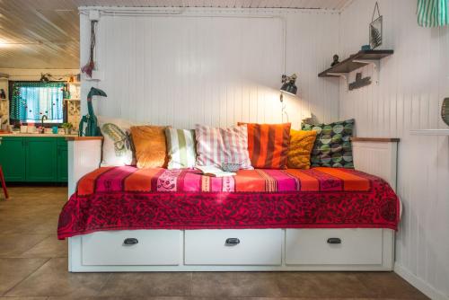 卡特兹奥布萨维Boho House 1 in camp Terme Catez的一张沙发,上面有五颜六色的枕头