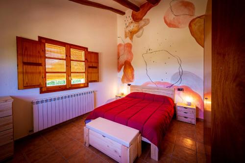 Font-RubíMasia Cal Magi的一间卧室配有一张带红色毯子的床
