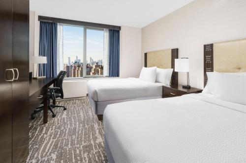纽约纽约曼哈顿中城/宾州车站万豪费尔菲尔德酒店 的酒店客房设有两张床和窗户。