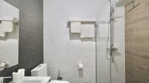 托雷维耶哈Hostal Lavela的带淋浴、卫生间和盥洗盆的浴室