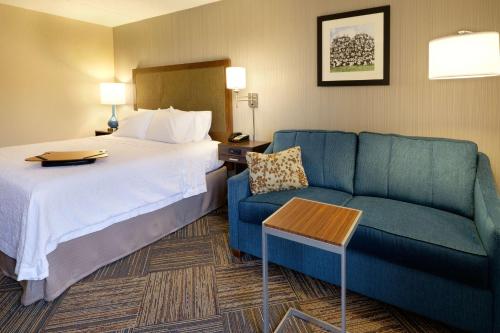 绿湾汉普顿格林湾市中心酒店 的酒店客房,配有床和沙发