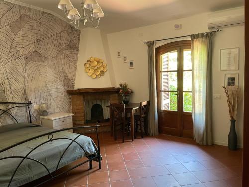 卢卡Casale I Tigli的一间带壁炉的卧室和一张位于客房内的床