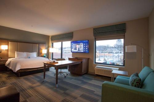 圣保罗圣保罗市中心汉普顿套房酒店的酒店客房设有一张床、一张书桌和一台电视机。