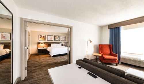 林夕昆高地Hilton Garden Inn BWI Airport的酒店客房设有一张沙发和一张床