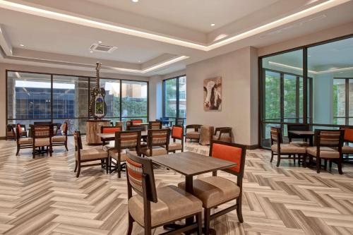 圣安东尼奥Home2 Suites By Hilton San Antonio Riverwalk的用餐室设有桌椅和窗户。
