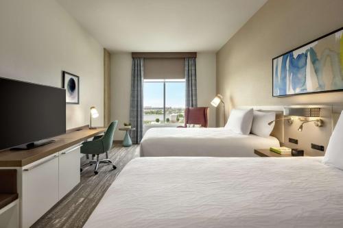 奥斯汀Hilton Garden Inn Austin North-Near the Domain, TX的酒店客房设有两张床和一台平面电视。