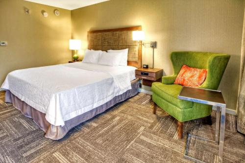 弗莱彻阿什维尔-I-26汉普顿旅馆及套房酒店的配有一张床和一把椅子的酒店客房