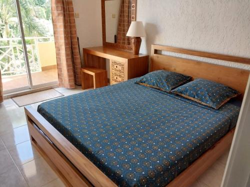 弗利康弗拉克Le Tamier - Amazing holidays的一间卧室配有一张带蓝色棉被的床