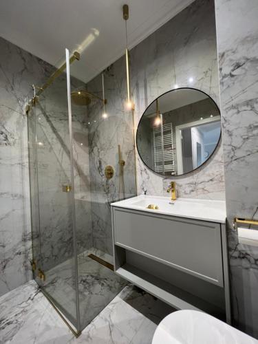 拉多姆Bella Casa Luxury Apartament的一间带水槽和镜子的浴室