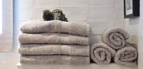 雷焦卡拉布里亚Campolo Apartment的浴室架子上的毛巾堆