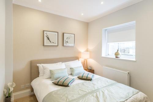 伦敦肯辛顿高街公寓的一间卧室配有一张带两个枕头的床