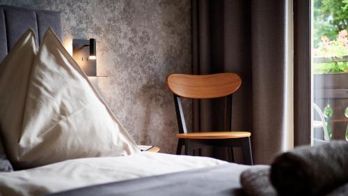 巴德哥依斯恩Jeff's - Rooms with a mountain view的卧室配有床、椅子和窗户。