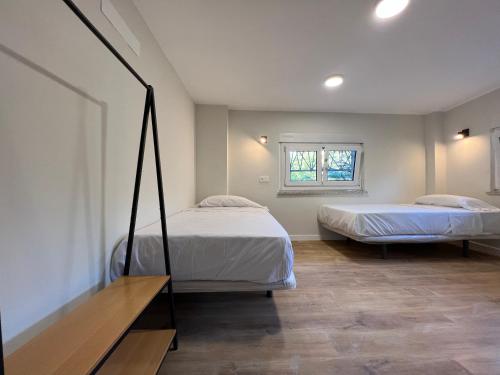 萨拉曼卡Hostal Mindanao的一间卧室设有两张床和窗户。