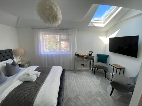 伯恩茅斯5 min from the beach ,parking in Guest House的一间卧室设有一张床、一台电视和一个窗口。