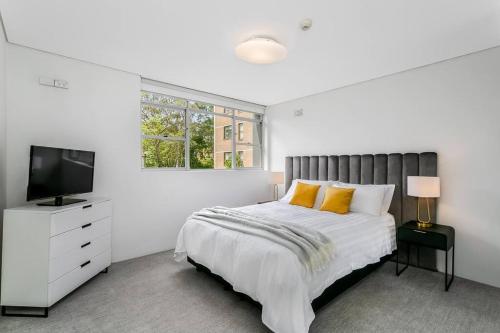 悉尼HAR20 - 2 bedroom Harrison Street - Cremorne的一间白色卧室,配有床和电视