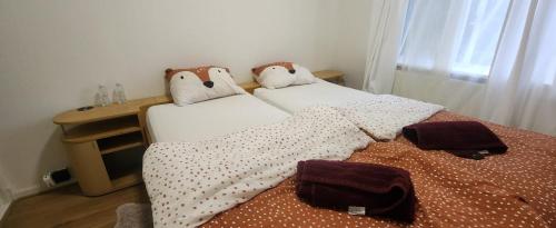 海牙2de double bed room的一间卧室配有两张带枕头和桌子的床