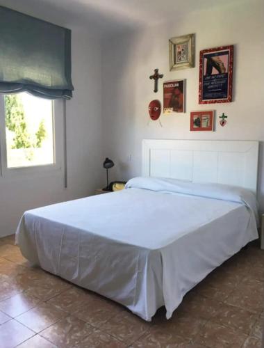 卡达克斯Apartamento renovado en Cadaqués的卧室内的一张大白色床,带有窗户