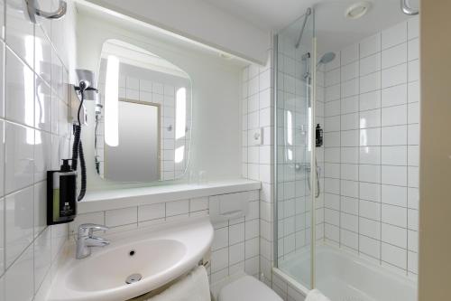 科隆科隆杜姆宜必思酒店的白色的浴室设有水槽和淋浴。