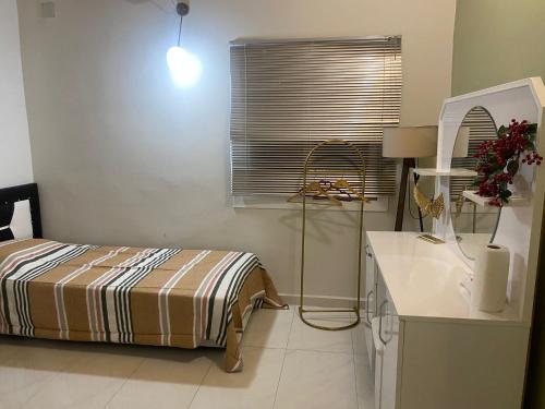 SamandağıLane Palmiye的一间卧室配有一张床、一张桌子和一个窗户。