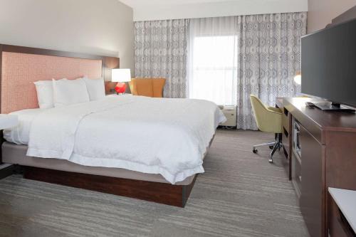 康科德康科德夏洛特汉普顿套房酒店的配有一张床和一台平面电视的酒店客房