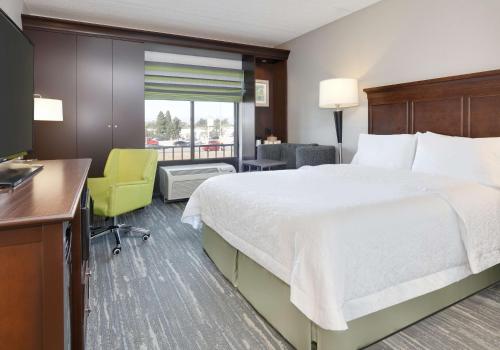 卡森洛杉矶/卡森汉普顿旅馆的酒店客房设有一张大床和一张书桌。