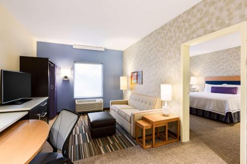 苏福尔斯苏福尔斯桑福德医疗中心希尔顿欣庭套房酒店的酒店客房设有床和客厅。