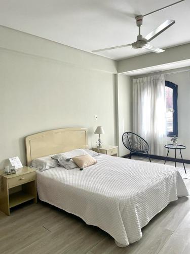 塔里哈Hotel Renacer Tarija的白色卧室配有床和吊扇