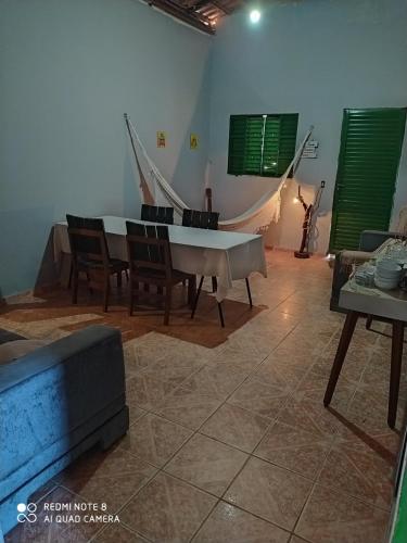 卡瓦坎特Hostel do Cerrado的客厅配有钢琴、椅子和沙发