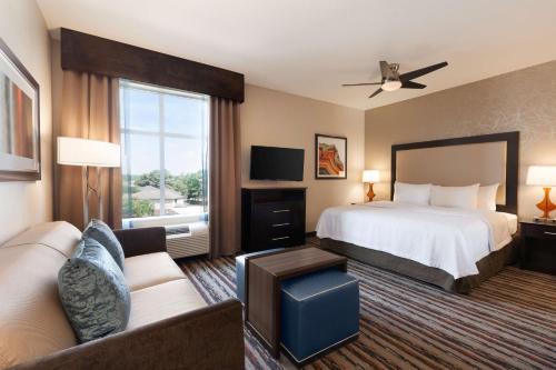 斯普林北休斯顿/斯普林希尔顿惠庭套房酒店的酒店客房,配有床和沙发