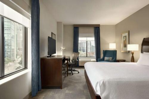 明尼阿波利斯明尼阿波利斯市区希尔顿花园旅馆的配有一张床、一张书桌和一扇窗户的酒店客房