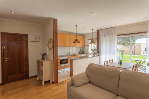 埃斯波森迪Litoral beach Apartment -- Esposende的带沙发的客厅和厨房