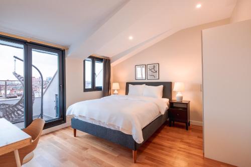 伊斯坦布尔Homie Suites - Newly Built Seaside Apartments on Bakırköy Shore的一间卧室设有一张床和一个大窗户