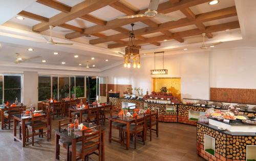 蒙纳Rivulet Resort的一间带木桌椅的餐厅和一间厨房