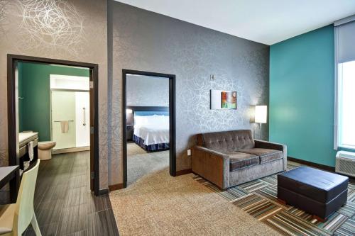 El RenoHome2 Suites By Hilton El Reno的带沙发的客厅和卧室