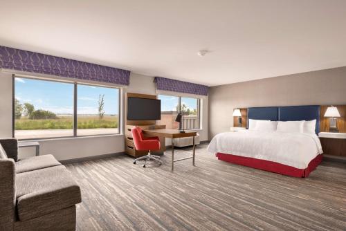 诺曼Hampton Inn & Suites Norman-Conference Center Area, Ok的配有一张床和一张书桌的酒店客房